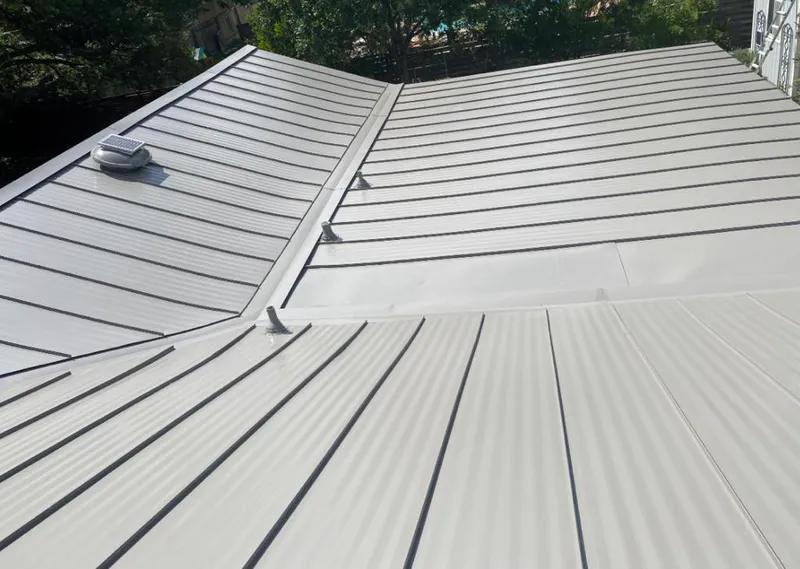 Solar attic fan installed on a metal roof for Roof Ventilation in Hitchcock