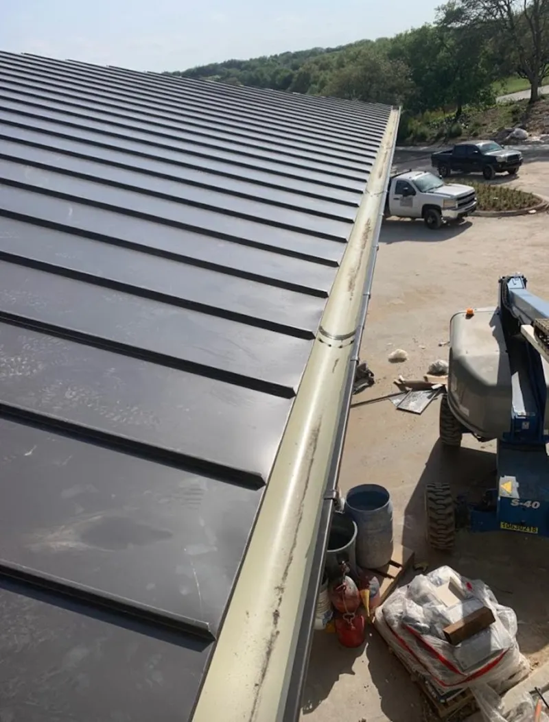 Standing seam panel and gutter detail on a metal roofing jobsite in Hitchcock